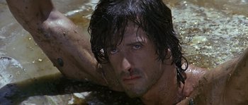 Movie still from “Rambo: First Blood Part II” (1985), directed by George P. Cosmatos – A person in a body of water; Close Up shot, High angle