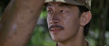 Movie still from “Rambo: First Blood Part II” (1985), directed by George P. Cosmatos – A person wearing a hat; Close Up shot, Over the shoulder angle