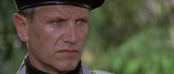 Movie still from “Rambo: First Blood Part II” (1985), directed by George P. Cosmatos – A person wearing a hat; Close Up shot, Low angle