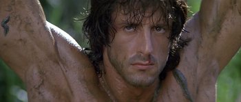 Movie still from “Rambo: First Blood Part II” (1985), directed by George P. Cosmatos – A person with wet hair; Close Up shot, Low angle