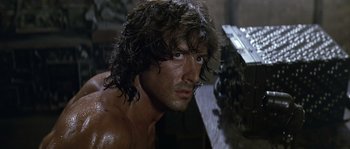 Movie still from “Rambo: First Blood Part II” (1985), directed by George P. Cosmatos – A person with long hair; Close Up shot, Low angle