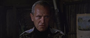 Movie still from “Rambo: First Blood Part II” (1985), directed by George P. Cosmatos – A person wearing a jacket; Close Up shot, Low angle