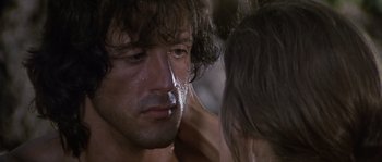 Movie still from “Rambo: First Blood Part II” (1985), directed by George P. Cosmatos – A man's face with water droplets on his face; Close Up shot, Over the shoulder angle