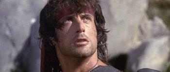 Movie still from “Rambo: First Blood Part II” (1985), directed by George P. Cosmatos – A person with wet hair; Close Up shot, Low angle