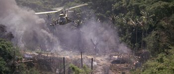 Movie still from “Rambo: First Blood Part II” (1985), directed by George P. Cosmatos – A helicopter flying through the air near a forest; Extreme Wide shot, High angle