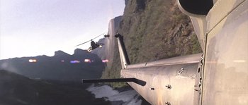 Movie still from “Rambo: First Blood Part II” (1985), directed by George P. Cosmatos – A person on a zipline over a mountain; Extreme Wide shot, High angle