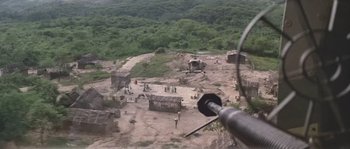 Movie still from “Rambo: First Blood Part II” (1985), directed by George P. Cosmatos – An aerial view of an area that is surrounded by trees; Extreme Wide shot, High angle