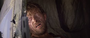 Movie still from “Rambo: First Blood Part II” (1985), directed by George P. Cosmatos – A person in a bed; Close Up shot, Low angle