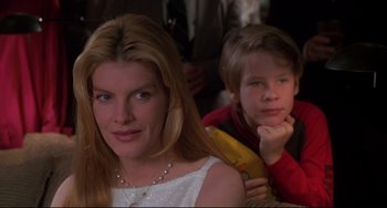 Movie still from “Ransom” (1996), directed by Ron Howard – A woman sitting next to a young boy in a room; Close Up shot, Over the shoulder angle