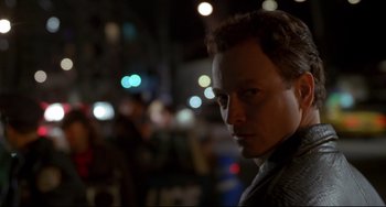 Movie still from “Ransom” (1996), directed by Ron Howard – A person in a dark room; Close Up shot, Over the shoulder angle