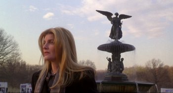 Movie still from “Ransom” (1996), directed by Ron Howard – A woman standing in front of a fountain; Medium shot, Low angle