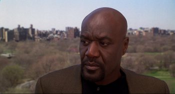 Movie still from “Ransom” (1996), directed by Ron Howard – A man with a beard is looking at the camera; Close Up shot, Low angle