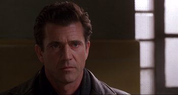 Movie still from “Ransom” (1996), directed by Ron Howard – A person wearing a leather jacket; Close Up shot, Over the shoulder angle