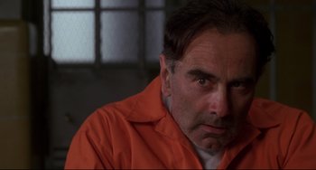 Movie still from “Ransom” (1996), directed by Ron Howard – A person wearing an orange jacket; Close Up shot, Over the shoulder angle