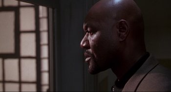 Movie still from “Ransom” (1996), directed by Ron Howard – A man's face looking off into the distance; Close Up shot, Low angle