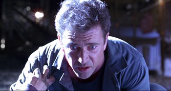 Movie still from “Ransom” (1996), directed by Ron Howard – A person wearing a black shirt; Close Up shot, Low angle