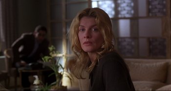 Movie still from “Ransom” (1996), directed by Ron Howard – A person sitting in a room near a window; Close Up shot, Over the shoulder angle