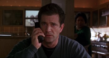Movie still from “Ransom” (1996), directed by Ron Howard – A man holding a cell phone up to his ear; Close Up shot, Low angle