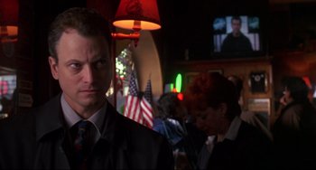 Movie still from “Ransom” (1996), directed by Ron Howard – A man wearing a suit and tie in a bar; Close Up shot, Low angle