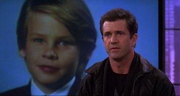 Movie still from “Ransom” (1996), directed by Ron Howard – A man standing in front of a picture of a child; Close Up shot, Low angle