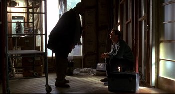 Movie still from “Ransom” (1996), directed by Ron Howard – Two men sitting in front of each other in a room; Medium shot, Low angle