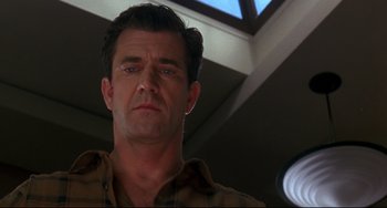 Movie still from “Ransom” (1996), directed by Ron Howard – A person wearing a brown shirt; Close Up shot, Low angle