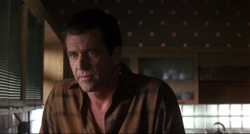 Movie still from “Ransom” (1996), directed by Ron Howard – A person wearing a plaid shirt; Close Up shot, Over the shoulder angle