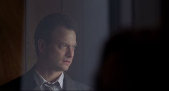 Movie still from “Ransom” (1996), directed by Ron Howard – A person wearing a suit and tie; Close Up shot, Low angle