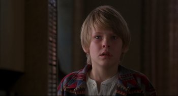 Movie still from “Ransom” (1996), directed by Ron Howard – A young boy is looking into the camera; Close Up shot, Over the shoulder angle