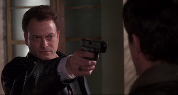 Movie still from “Ransom” (1996), directed by Ron Howard – A man holding a gun in front of a mirror; Close Up shot, Over the shoulder angle