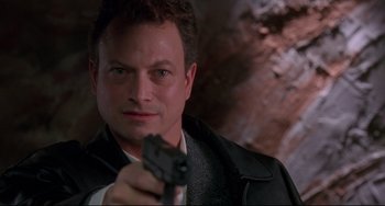 Movie still from “Ransom” (1996), directed by Ron Howard – A person holding a gun; Close Up shot, Low angle