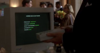Movie still from “Ransom” (1996), directed by Ron Howard – A person holding a nintendo wii controller in front of a computer screen; Extreme Close Up shot, Over the shoulder angle