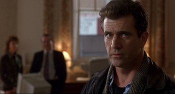 Movie still from “Ransom” (1996), directed by Ron Howard – A person wearing a suit and tie; Close Up shot, Low angle