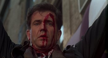 Movie still from “Ransom” (1996), directed by Ron Howard – A person with blood on his face; Close Up shot, Low angle