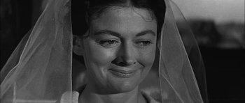Movie still from “Rapture” (1965), directed by John Guillermin – An old photo of an older woman smiling for the camera; Close Up shot, Low angle