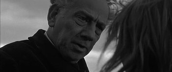 Movie still from “Rapture” (1965), directed by John Guillermin – An older man is looking at a young woman; Close Up shot, Low angle