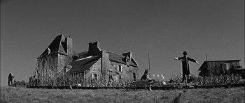 Movie still from “Rapture” (1965), directed by John Guillermin – An old farm house with a woman sitting on the front lawn; Extreme Wide shot, Low angle