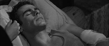 Movie still from “Rapture” (1965), directed by John Guillermin – A person laying in a bed; Close Up shot, High angle