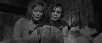 Movie still from “Rapture” (1965), directed by John Guillermin – Two young women are looking at a camera; Close Up shot, Low angle