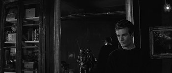 Movie still from “Rapture” (1965), directed by John Guillermin – A group of men standing next to each other in front of a mirror; Close Up shot, Over the shoulder angle