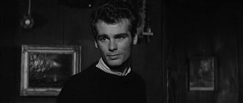 Movie still from “Rapture” (1965), directed by John Guillermin – Black and white photograph of a man in a sweater; Close Up shot, Low angle