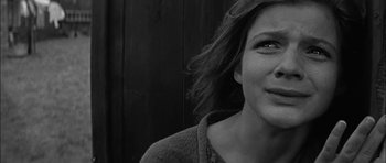 Movie still from “Rapture” (1965), directed by John Guillermin – A black - and - white photo of a woman's face; Close Up shot, Low angle