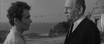 Movie still from “Rapture” (1965), directed by John Guillermin – A man and a woman talking to each other; Medium shot, Low angle