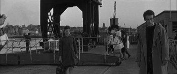 Movie still from “Rapture” (1965), directed by John Guillermin – An old black and white photo of a woman and two children; Wide shot, High angle