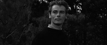 Movie still from “Rapture” (1965), directed by John Guillermin – Black and white photograph of a young man in a sweater; Close Up shot, Low angle