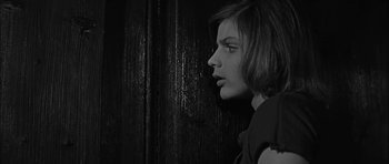 Movie still from “Rapture” (1965), directed by John Guillermin – A black - and - white photo of a woman looking into the distance; Close Up shot, Low angle
