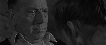 Movie still from “Rapture” (1965), directed by John Guillermin – An older man and a younger woman looking at each other; Close Up shot, Over the shoulder angle