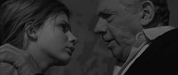 Movie still from “Rapture” (1965), directed by John Guillermin – An older man and a younger woman face to face; Close Up shot, Low angle