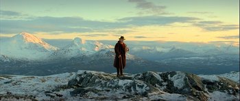 Movie still from “Rare Exports” (2010), directed by Jalmari Helander – A man standing on top of a snow covered hill; Extreme Wide shot, Low angle