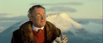 Movie still from “Rare Exports” (2010), directed by Jalmari Helander – An older man wearing glasses and a fur coat; Close Up shot, Low angle